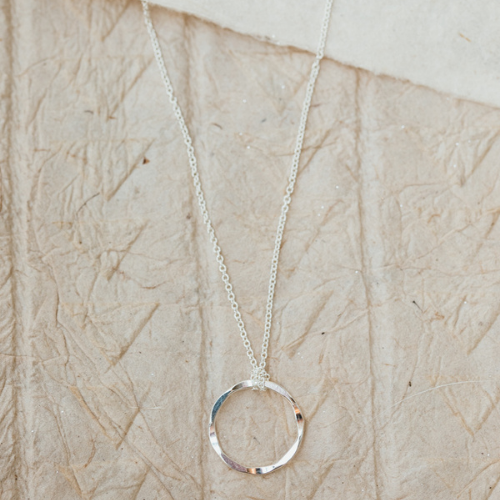 5 Gifts Under $50: Veronica & Harold Claire Hammered Hoop Necklace with neutral background